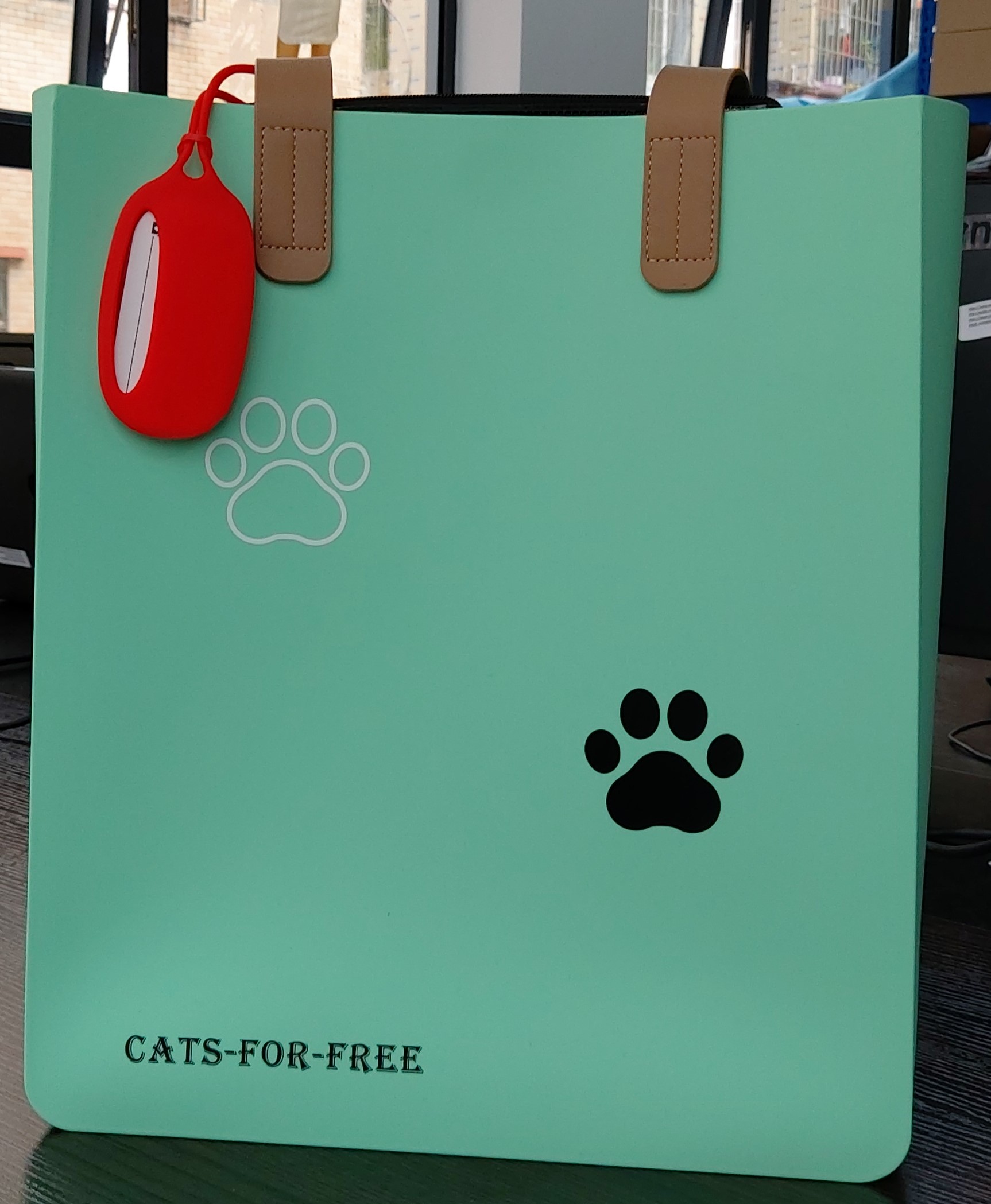 green silicone bag with cat paws logo