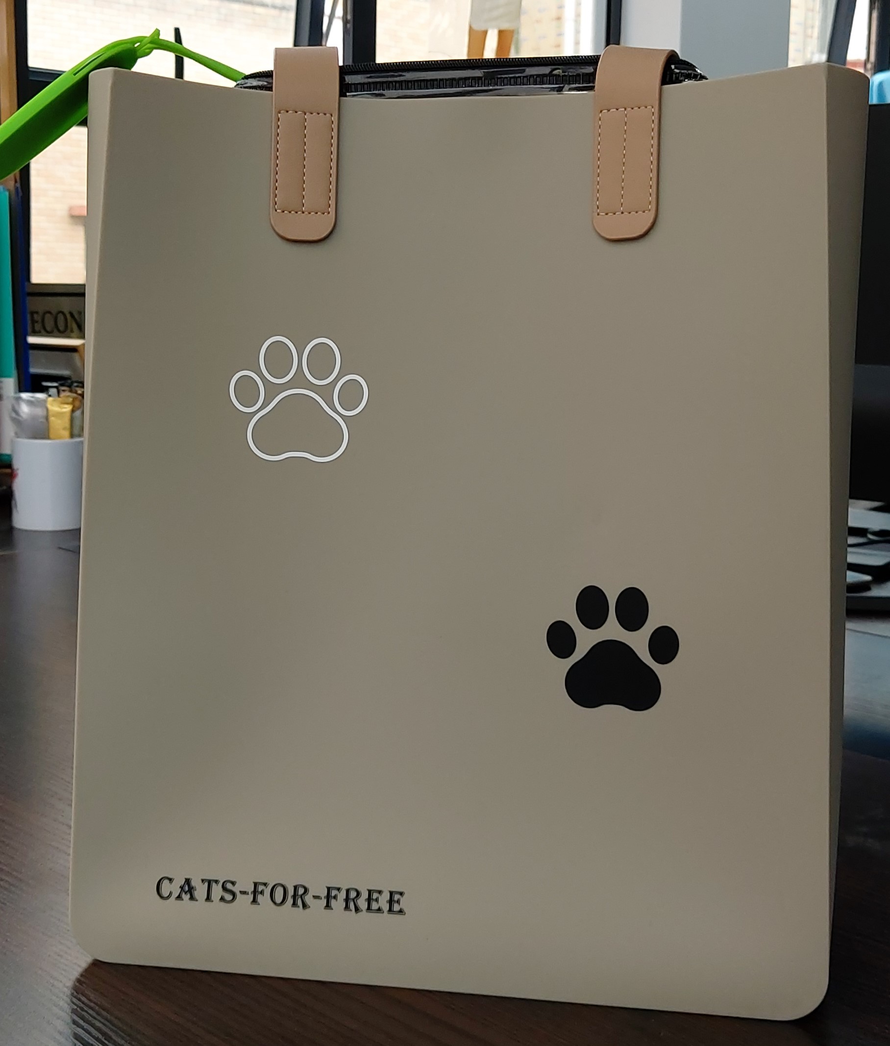 beige silicone bag with cat paws logo